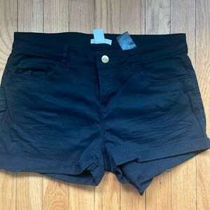 Black shorts, gold button